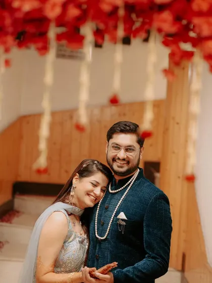 A sweet and happy portrait of the couple during their Mehendi ceremony. The bride rests her head on the groom's shoulder, sharing a moment of comfortable love.