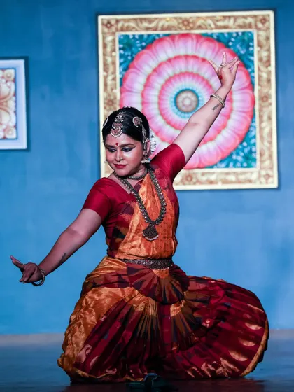 Another moment from the Natyanjali recital, this pose captures the grace and expansive energy of the dance. The vibrant colors of the costume and the artistic background came together to create a beautiful visual story on stage.