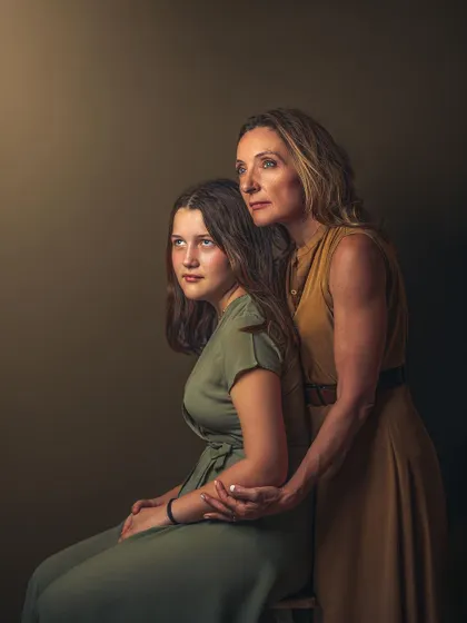 A more formal, painterly portrait of Petra and Maja. Their gazes are directed towards a single light source, creating a dramatic, classical look. This image is a testament to the enduring bond between them, captured with an artistic, old-world feel.
