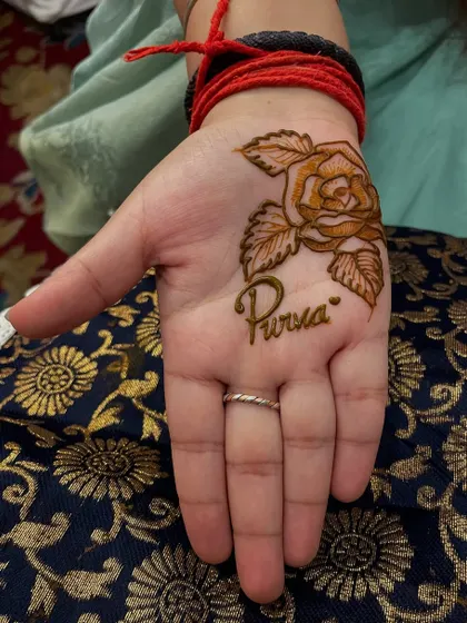 A simple and sweet design featuring a single rose with the name 'Purva' written below. This is perfect for someone who wants a small but personal touch.