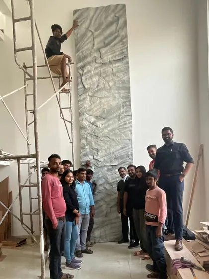 Our team on site, installing a custom-sculpted stone panel. This piece was designed to bring the rugged beauty of the adjacent quarry into the heart of the home, a testament to our hands-on approach and commitment to artistry.