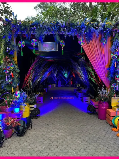 An entrance to a neon dream. This walkway for a Haldi party is designed to be an immersive experience, with colorful lighting and unique props creating a futuristic and fun vibe.