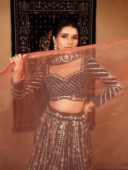 A playful and coy shot for a lookbook, using the dupatta to frame the model's face. This adds personality and engagement to the image.