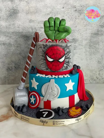An Avengers cake packed with action for a 7th birthday! I included all the iconic elements: Hulk’s fist smashing through the top, Thor’s hammer, Captain America’s shield, and Spider-Man’s mask.