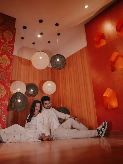 A cozy, relaxed moment for a couple on the floor of our royal room, surrounded by unique hanging lamps.