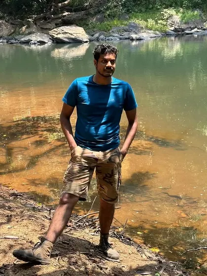 A solo shot of a trekker by the river, enjoying the calm and quiet.
