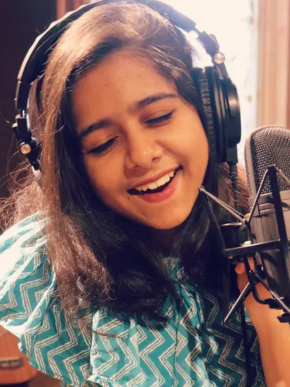 A smile during a recording session. Music brings me immense joy, and I hope to share that feeling with every track I sing on. I believe a happy artist creates heartfelt music.