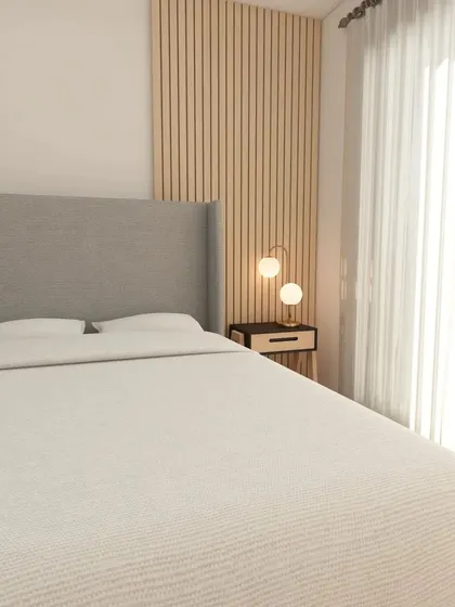 The bed in this Scandinavian room features a simple grey upholstered headboard against a backdrop of vertical wood slats, adding texture and warmth to the minimalist design.