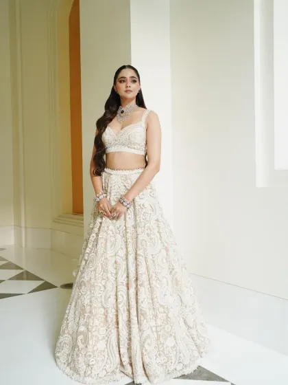 A classic portrait of the bride in her all-white ensemble, a symbol of modern purity and elegance.