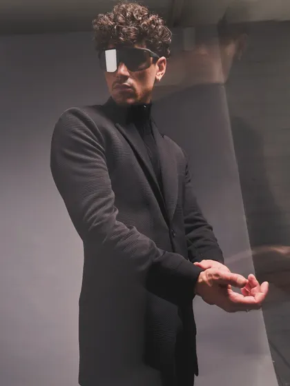 A lesson in monochromatic layering. I styled this all-black look with a focus on texture and silhouette, adding futuristic sunglasses for an avant-garde edge.