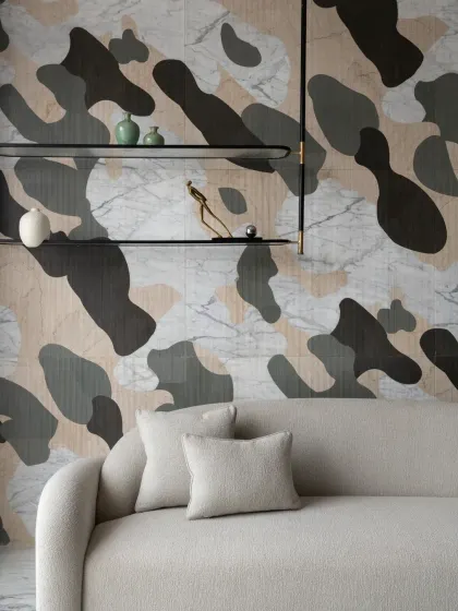 One wall of the drawing room in The House of Dancing Screens features this unique abstract painting crafted from an assortment of natural stones. The intricate design combines various marbles to create a visually appealing masterpiece.