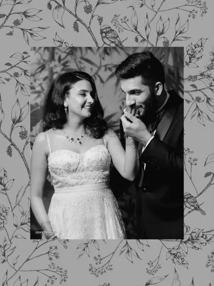 A soft, romantic black and white portrait with a floral overlay, capturing a tender moment between the couple during their elegant evening celebration.