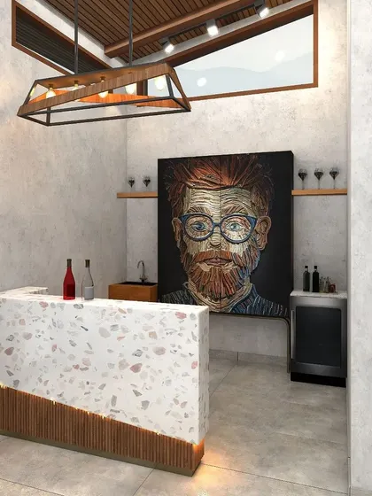 A distinctive bar area with a terrazzo stone counter and a unique portrait art piece serves as a stylish focal point in the lounge.