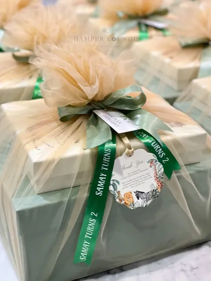 Another view of the beautifully wrapped safari-themed return gifts, showing the custom ribbon and tag. I handle bulk orders with precision to ensure every single gift is perfect.