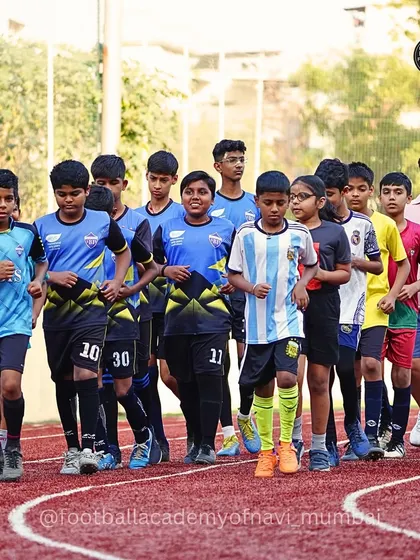 A team of older players runs on a track, part of our comprehensive fitness and conditioning program designed to build stamina and speed.