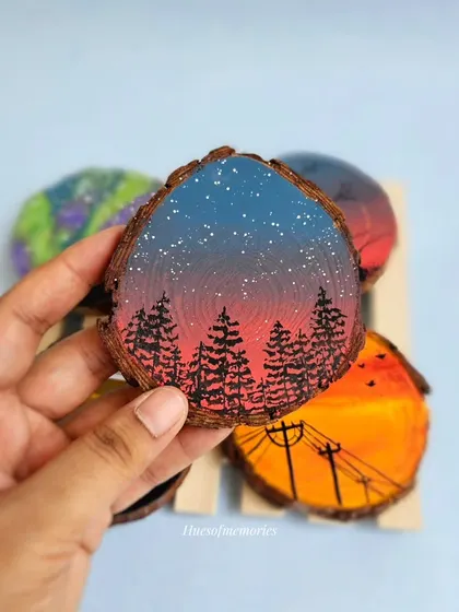 Add a touch of artistic flair to your home with this splash-proof, hand-painted wooden magnet. This one features a beautiful night sky landscape over a forest.