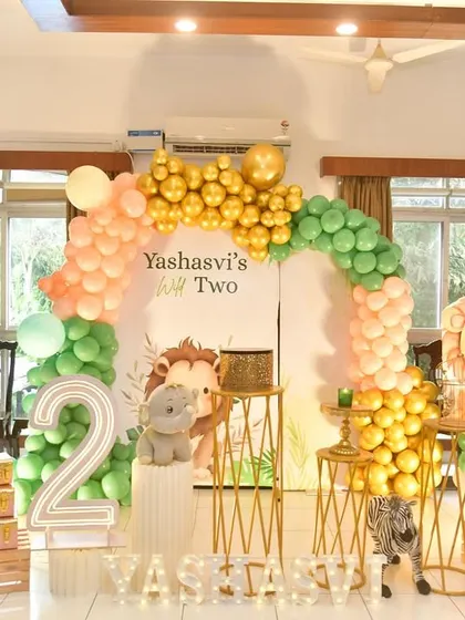 A sweet jungle theme for a second birthday, using pastel colors and cute, friendly animal cutouts.