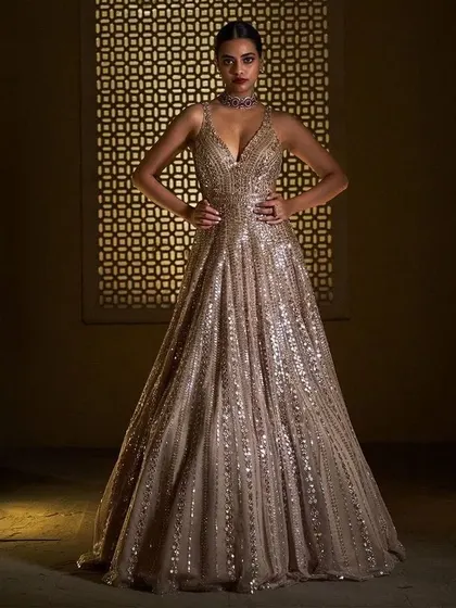 This sequined gown is designed for maximum sparkle. The deep V-neck and flowing skirt make it a perfect choice for a night of dancing and celebration.