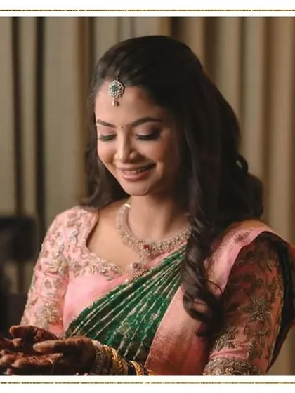 Another beautiful shot of this bride's soft and elegant look. The focus is on her serene expression and the delicate details of her makeup and attire.