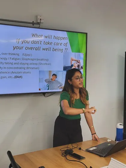 Presenting on the importance of overall well-being and the consequences of neglecting it, such as stress and low energy.
