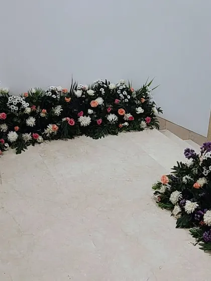 A ground-level view of the staircase decor, showing how the floral runners guide guests up to the main event area.