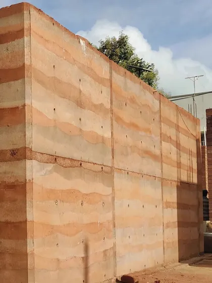 A large section of a rammed earth wall, showcasing its scale and beauty.