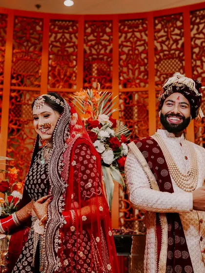 A candid moment of laughter between the bride and groom. This photo captures the genuine joy and fun of the wedding day.