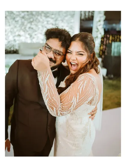 A candid moment of pure joy and fun between the bride and a guest. This photo captures the uninhibited energy and happiness of the reception.