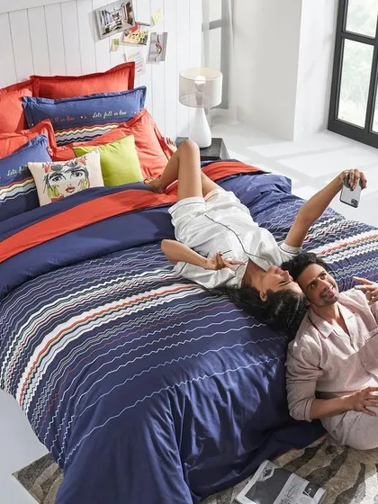 An overhead shot capturing a fun, modern moment. This image for a 'His & Hers' collection uses a playful, social media-centric theme to connect with a younger audience.