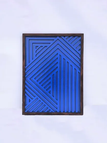 A centered shot of one of the blue geometric panels against a clean white background, highlighting its bold color and sharp lines.