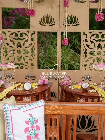 A close-up of the decor on the Haldi seating, with silver elephant props and hanging floral tassels.