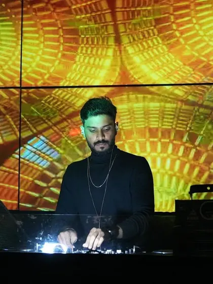 Focused on the mix, framed by the incredible psychedelic visuals on the LED wall. The synergy between audio and visuals is key.