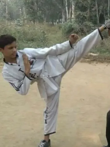 A student executes a clean, high kick. This level of technique comes from countless hours of practice and dedication to form.