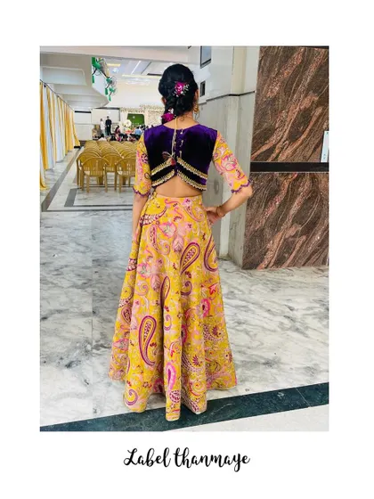 Another look at the back of the custom velvet blouse, paired with the vibrant printed skirt.