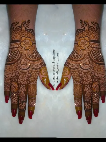 A beautiful floral design on the hands, complemented by red nails.