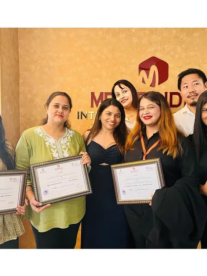 A diverse group of students, now certified professionals, celebrating their achievement together.