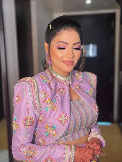 Just a sprinkling of studs to take Krisha's carnival look to the next level. I used purple tones on her eyes and face gems for a fun, festive vibe.