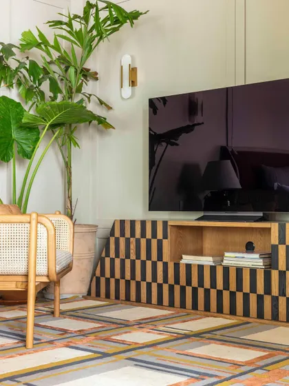 A detail of the den in Summer Haus, featured in Elle Decor. The geometric pattern on the console and the textured rug add layers of visual interest to the room.