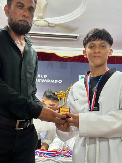 A trophy for a champion. It's an honor to present this award to one of our dedicated Taekwondo students.