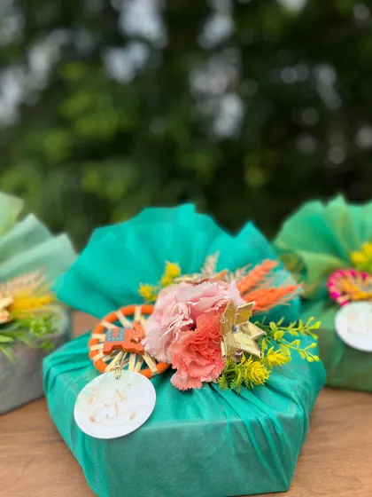 A trio of brightly wrapped gifts, showcasing different color combinations and floral arrangements suitable for any festive celebration.