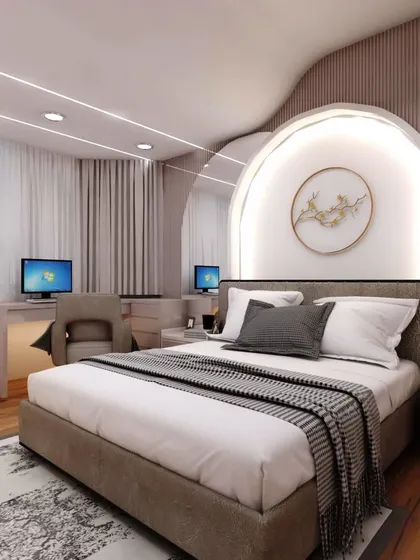 This bedroom was designed for a client's daughter, featuring a unique arched headboard with integrated lighting. The space also includes a dual-monitor study desk, blending relaxation with productivity.