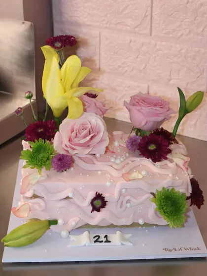 Rectangle cakes have entered the chat. This new shape is perfect for our cottagecore designs, like this pink cake adorned with a beautiful arrangement of fresh flowers.