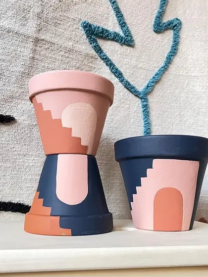 Inspired by architectural shapes and desert colors, these hand-painted planters feature abstract arch and stair designs. They bring a warm, contemporary feel to your plant display.