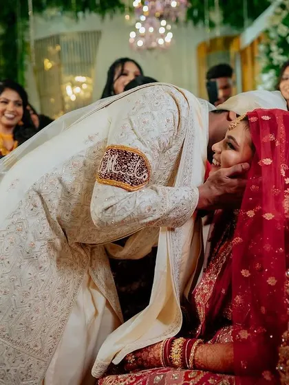 A tender kiss seals the vows. This intimate moment during the ceremony is a beautiful expression of the couple's new union, captured candidly.