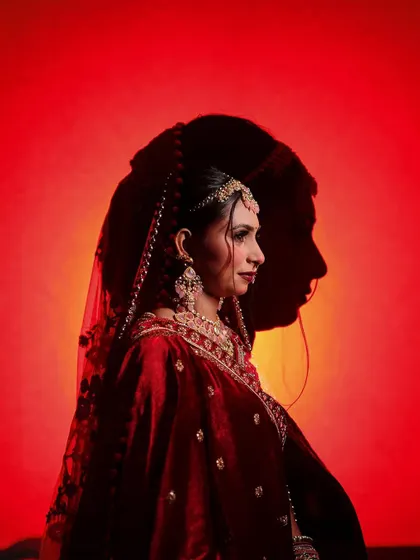 A creative and powerful portrait using shadows to create a silhouette of the groom behind the bride, symbolizing their unity.