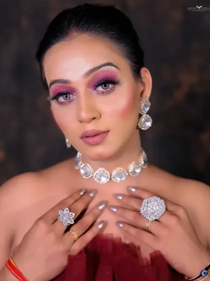 A close-up focusing on the statement diamond jewelry and the model's flawless makeup.