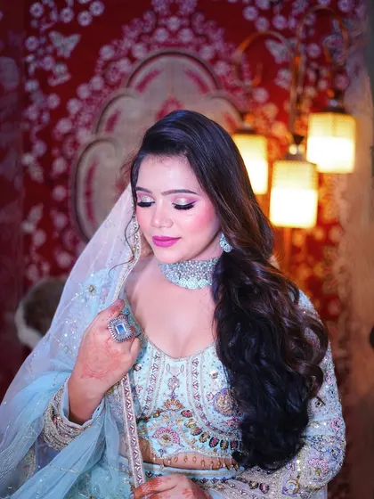 A close-up of our sky-blue peacock motif lehenga, showing the delicate embroidery and the beautiful sheer dupatta.