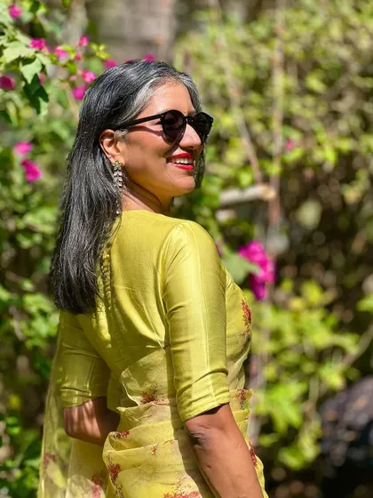 Another look at the organza saree, highlighting the delicate fabric and the elegant potli detail on the back of the blouse.