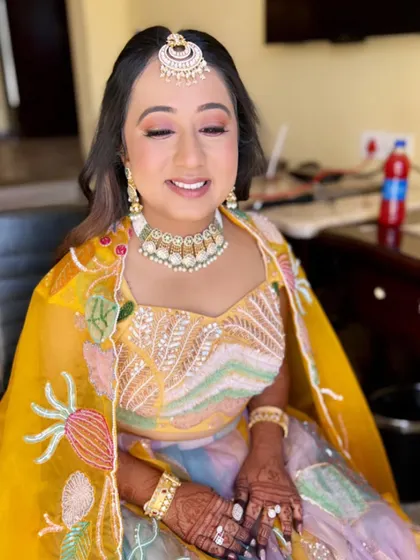 A beautiful, smiling bride-to-be. Her makeup is minimal and radiant, perfect for a sun-filled celebration.