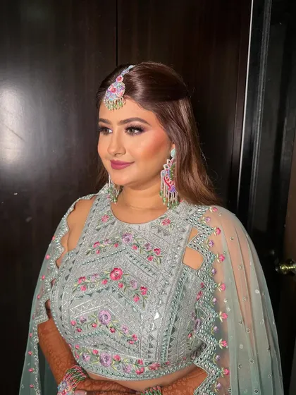 This side profile highlights her glowing skin and the intricate details of her floral-inspired jewelry.
